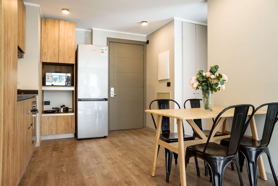 Cozy kitchen and dining area with modern appliances and a welcoming atmosphere, perfect for intimate meals.