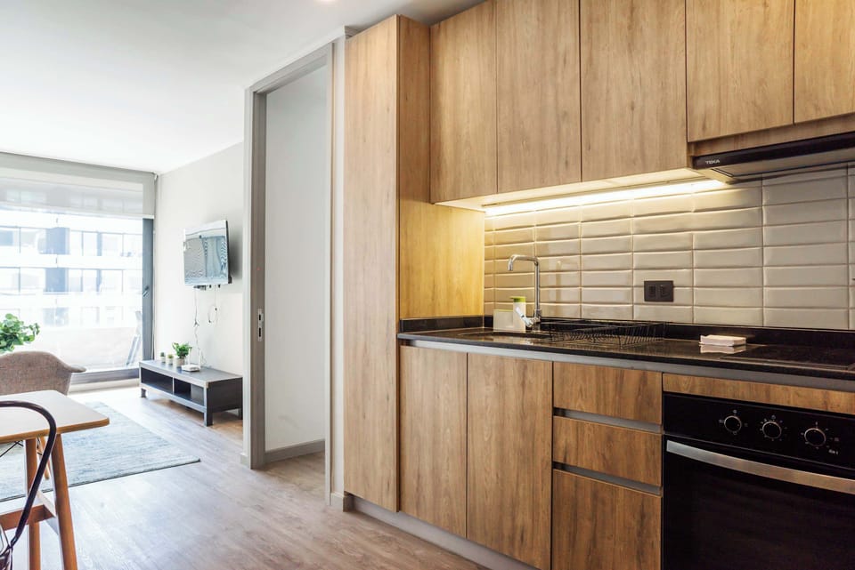 Experience modern living with this stylish kitchen and cozy living area, bathed in natural light.