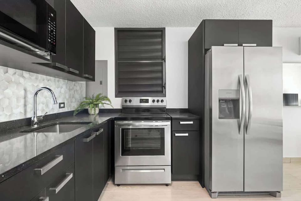 A bright and sleek kitchen with modern appliances.

