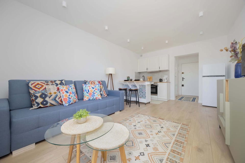 A comfortable sofa with colorful cushions brings energy and a cheerful touch to the interior.