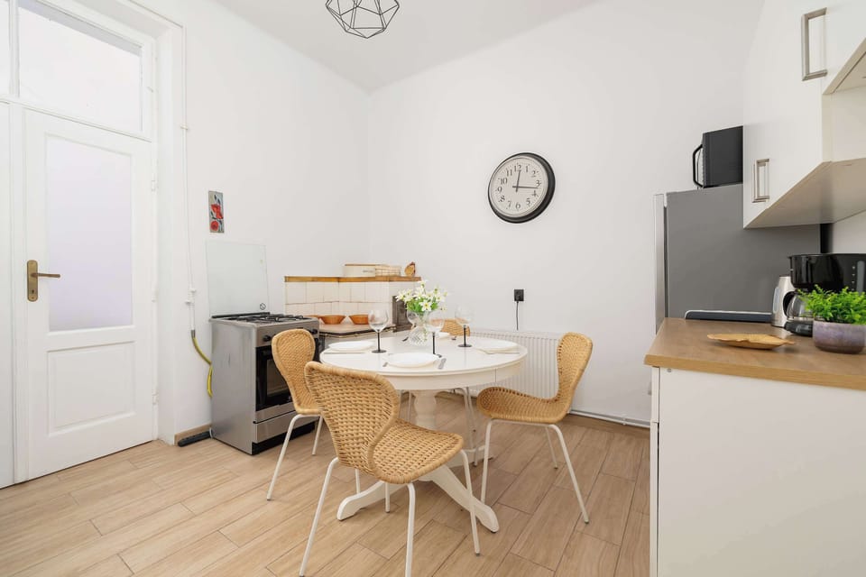 A functional kitchen with a dining table and chairs, perfect for shared meals.