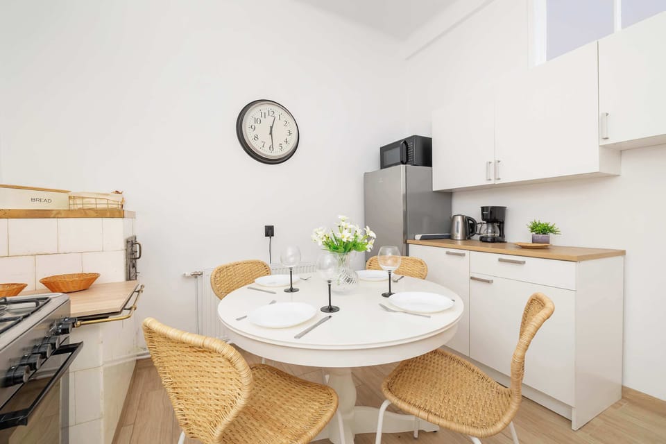 A dining area with a round table and chairs, seamlessly connected to the kitchen. The design feels both stylish and practical.
