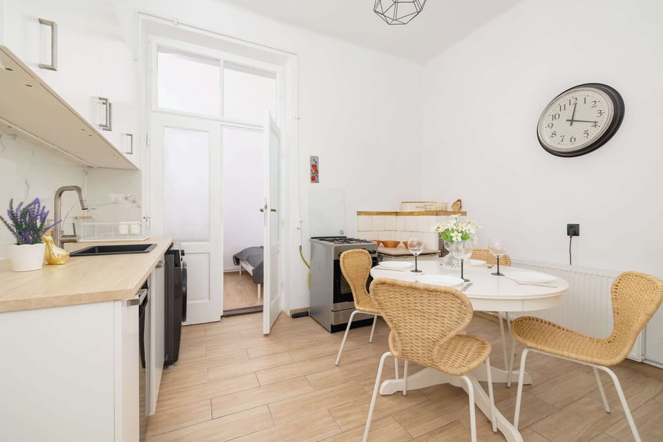 A kitchen and dining corner with a small round table and chairs. Modern appliances provide convenience.