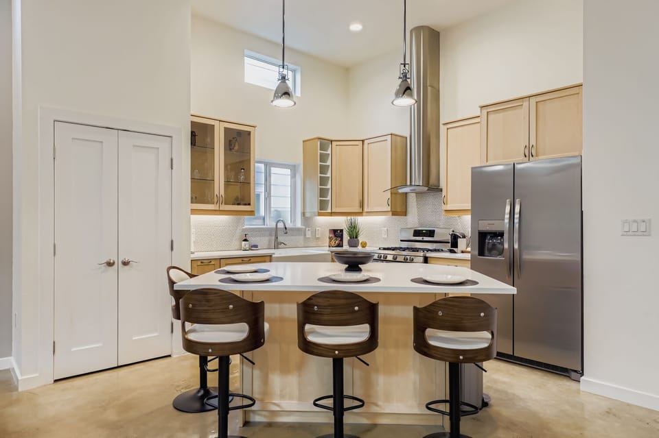 Sleek kitchen design with bar seating for casual meals or morning coffee.