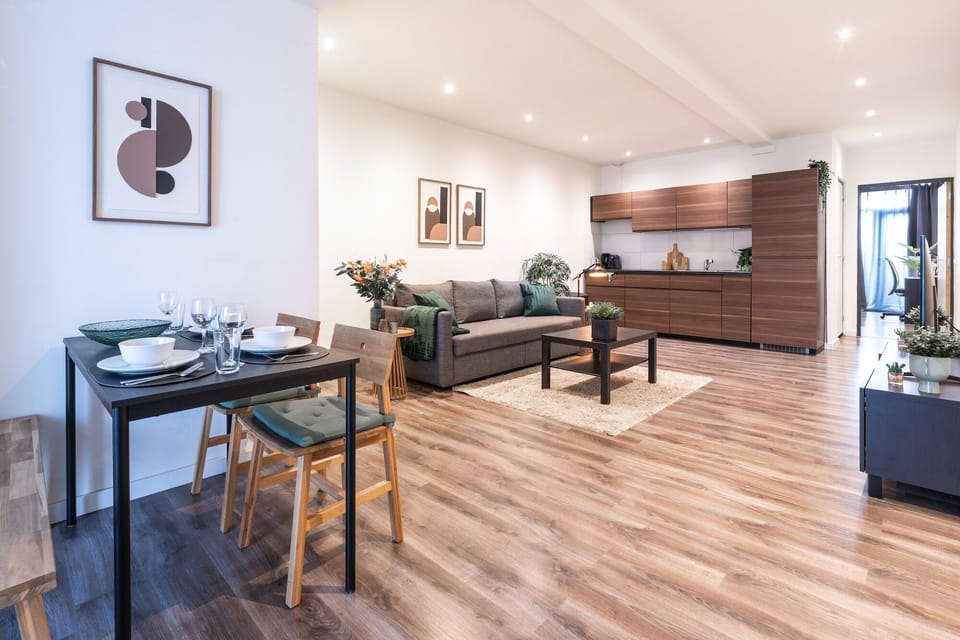 Well-lit living room with comfortable seating and dinning.