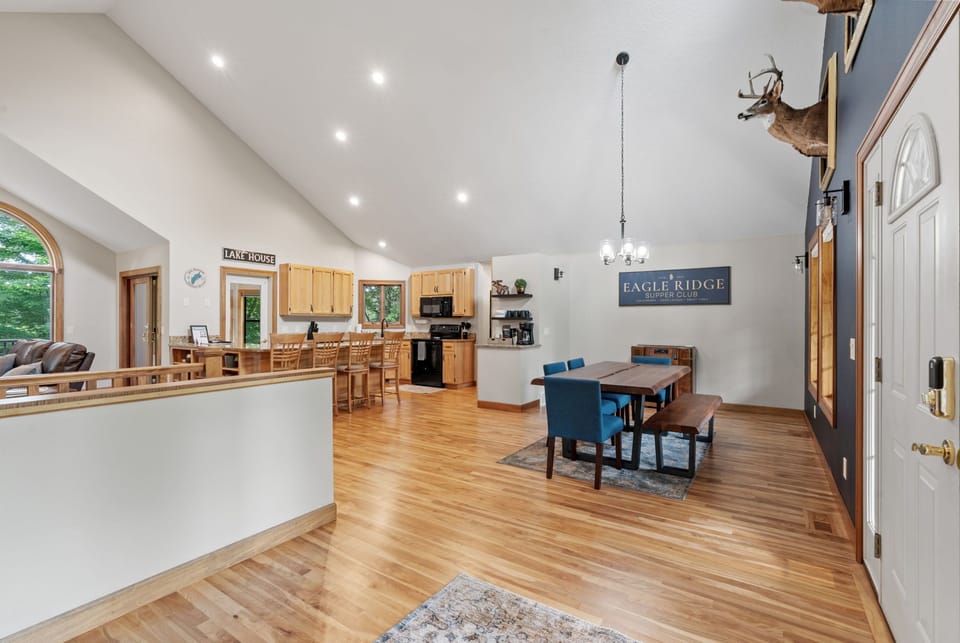 Gather around the spacious dining table while the chef prepares meals in your fully equipped kitchen with warm wood tones.