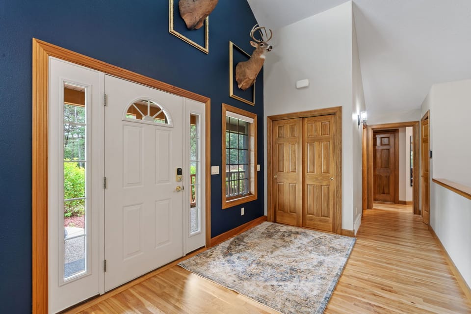 Step into your welcoming entryway with soaring ceilings, rich wood trim, and rustic charm that sets the perfect mountain retreat tone.