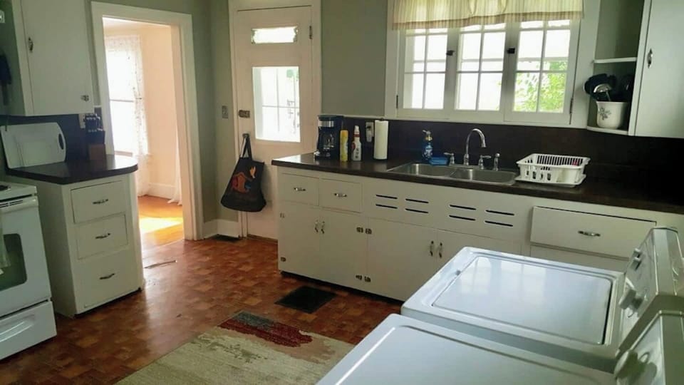 A kitchen with all the cooking appliances and utensils provided