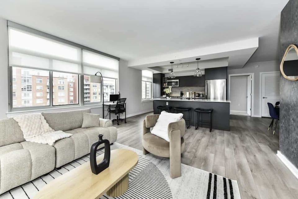 Chic and bright living room with cozy couch, flatscreen Tv and dedicated work station