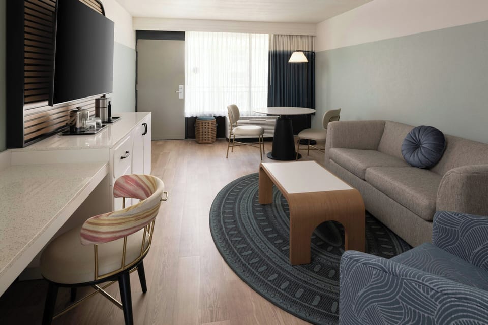 Suite, 1 Bedroom, Pool View | Living area | 42-inch flat-screen TV with cable channels, TV, iPod dock