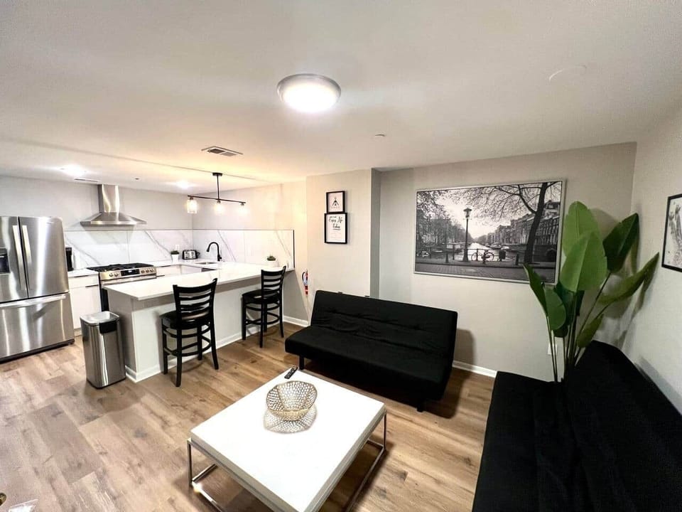 The living room features two comfortable futon sofa beds, perfect for relaxing or accommodating extra guests. 55 inch flat-screen TV, equipped with a variety of Roku channels, and an electric fireplace..