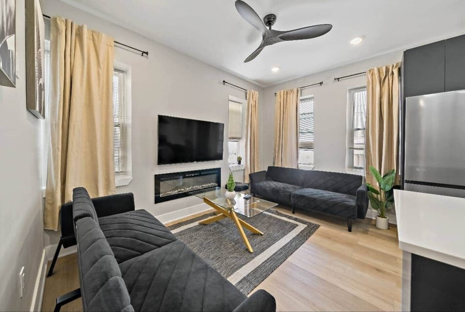 Welcome to our stylish modern living room! Enjoy two cozy sofa beds, a fireplace, and a large flat-screen TV with Ruko, Apple TV, and Netflix. Stay connected with complimentary WiFi and relax with Boardwalk and ocean views.