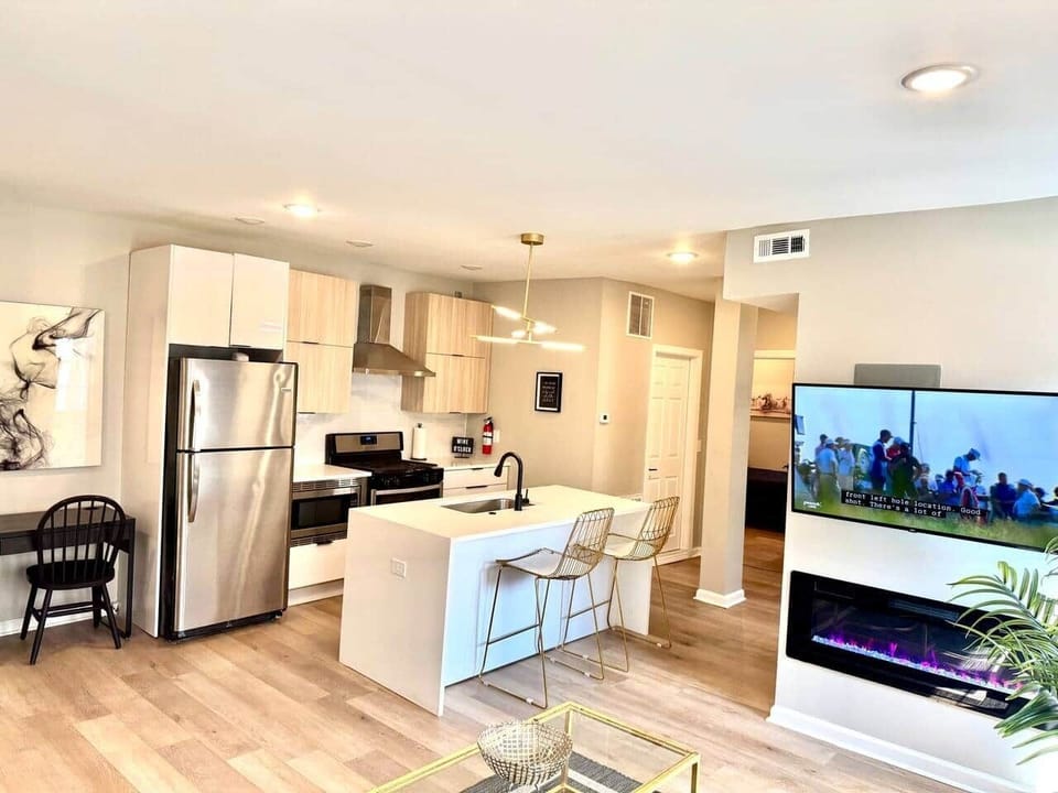 Discover a beautifully decorated living room featuring two sofas, a cozy bed, and a charming fireplace. This inviting space includes a large flat-screen TV & convenient access to a balcony that connects to the kitchen, great relaxation &entertaining.