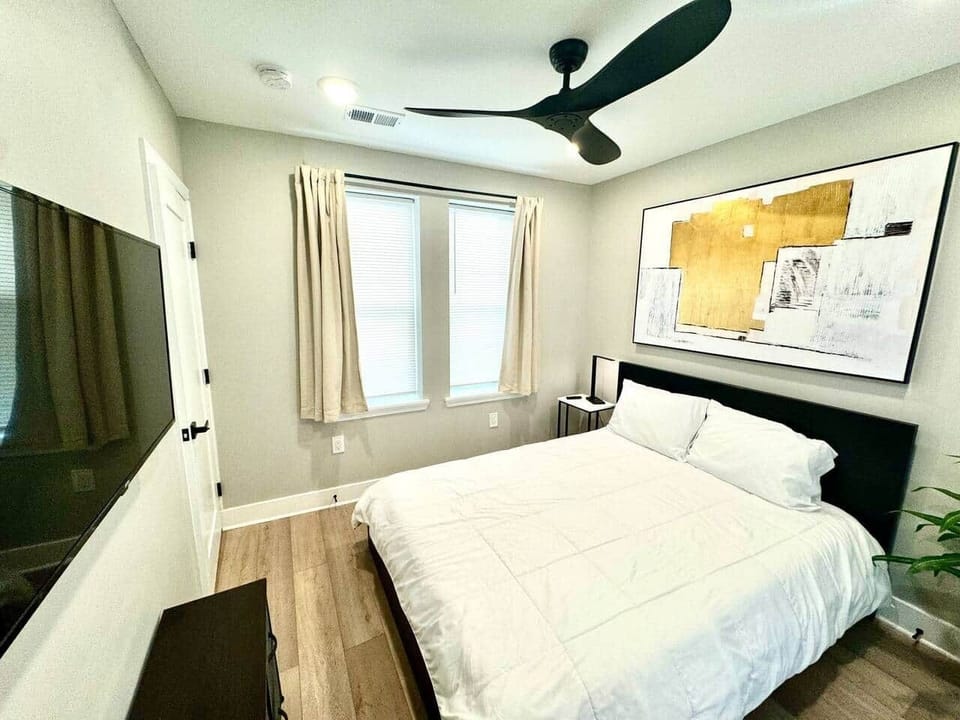 This comfortable bedroom includes a queen bed, flat-screen TV, ceiling fan, darkening curtains, a side table, USB charging, lamp, and a spacious closet for all your storage needs.