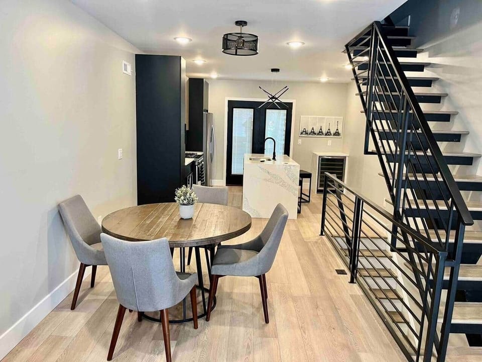 The dining room seamlessly flows into the living room, A harmonious connection between the two areas. The living space is adorned with a flat-screen TV, ideal for relaxation, and includes two comfortable futon sofa beds for added accommodation.