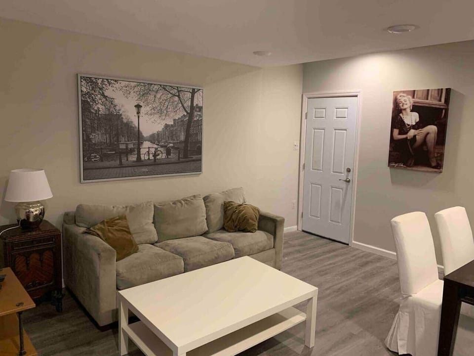 Living room and dinning room with tv amd and a pull out sofa bed.
