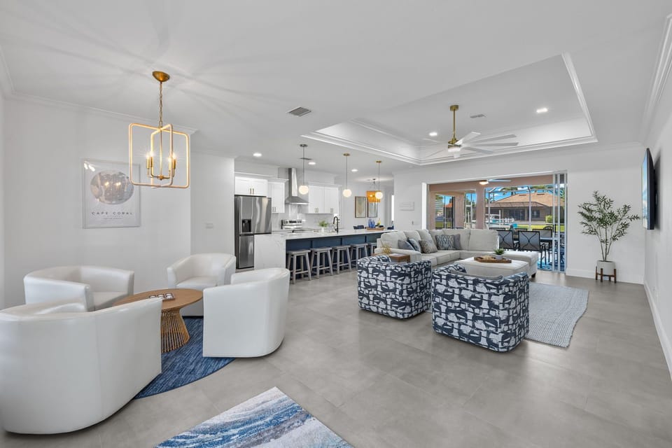 Front door view of the sitting area, main living room, kitchen and outdoor space