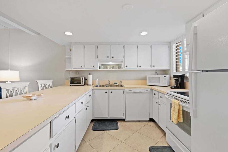 Condo, 1 Queen Bed with Sofa bed, Patio, Pool View (Ocean Club North C104) | Private kitchen | Dining tables
