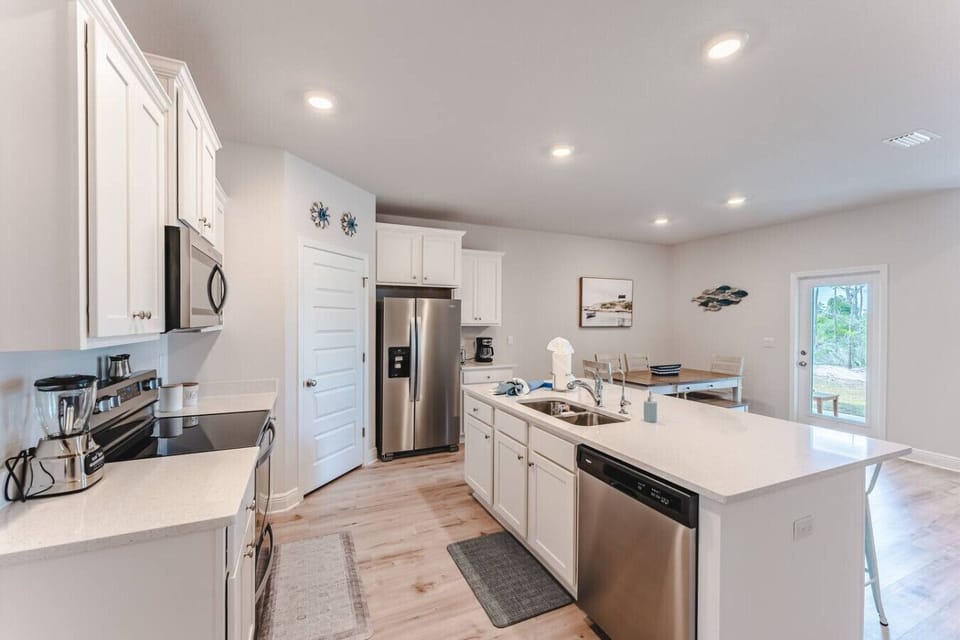 Kitchen with walk-in pantry stocked with essential items, Blender, Toaster, Coffee Maker.