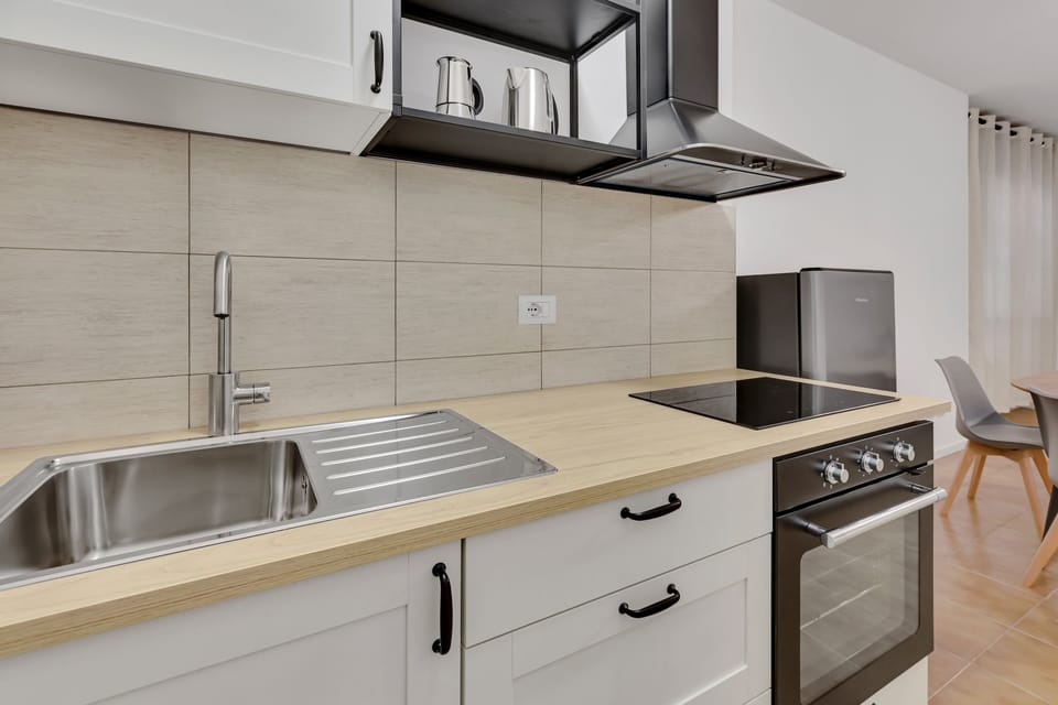 Comfort Apartment | Private kitchen | Espresso maker, electric kettle, cleaning supplies, freezer
