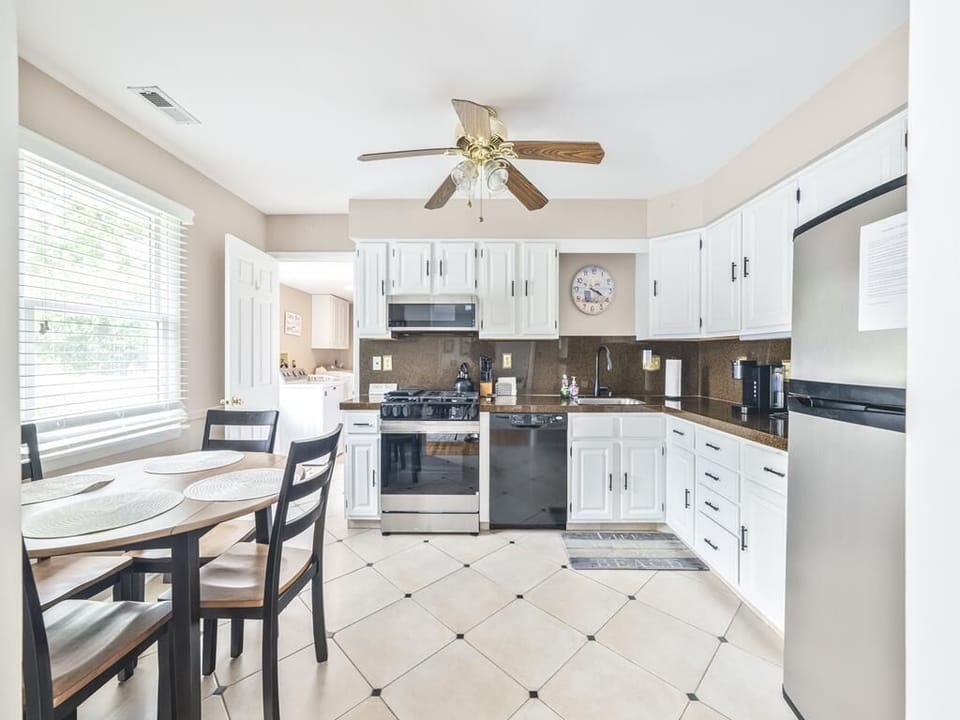 The well-equipped kitchen boasts modern appliances, ample storage, and a breakfast nook perfect for morning coffee.