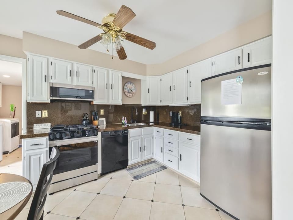 Cook with ease in a bright kitchen that combines functionality with charm, highlighted by sleek countertops and white cabinetry.