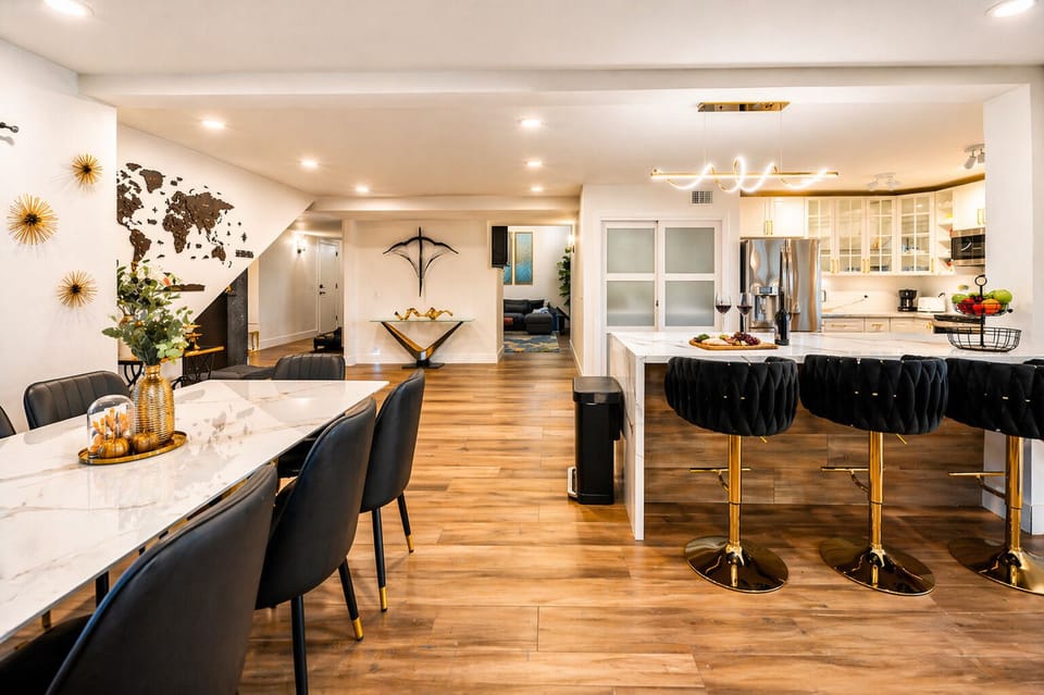 Modern Open Kitchen & Dining with Elegant Black-and-Gold Design