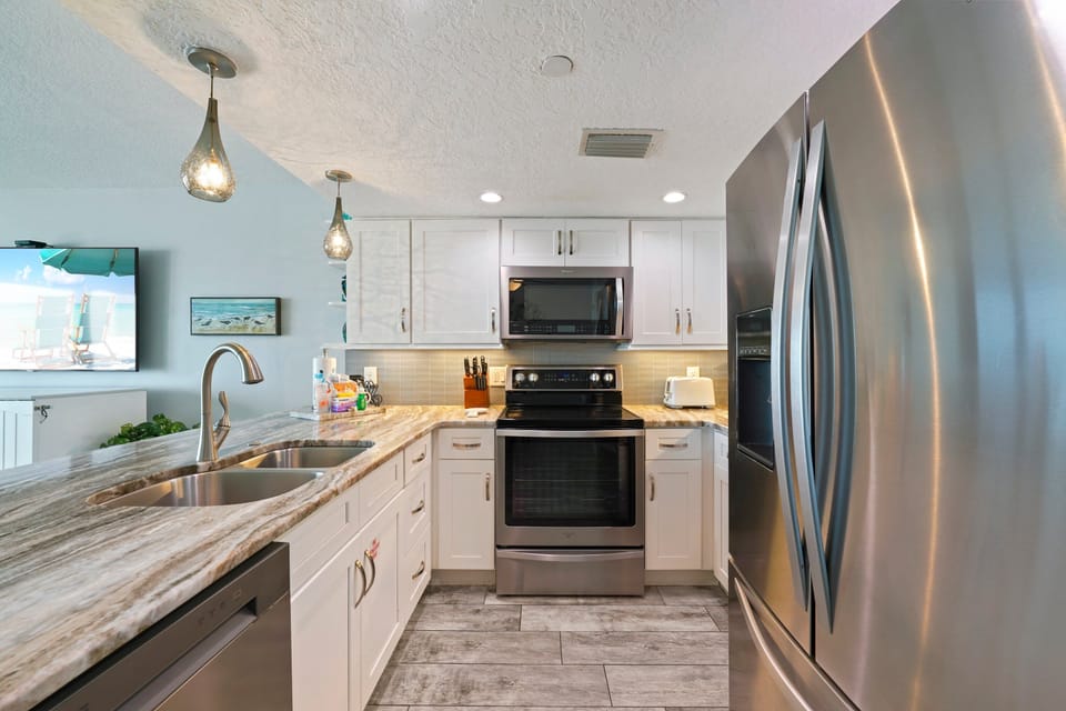 Clean lines, bright finishes, and warm touches create a space that feels both elegant and comfortably lived in.