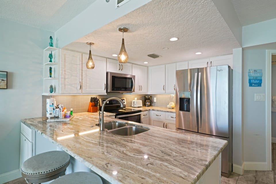 Where mornings start with coffee at the breakfast bar and evenings end around the table sharing stories from the beach.
