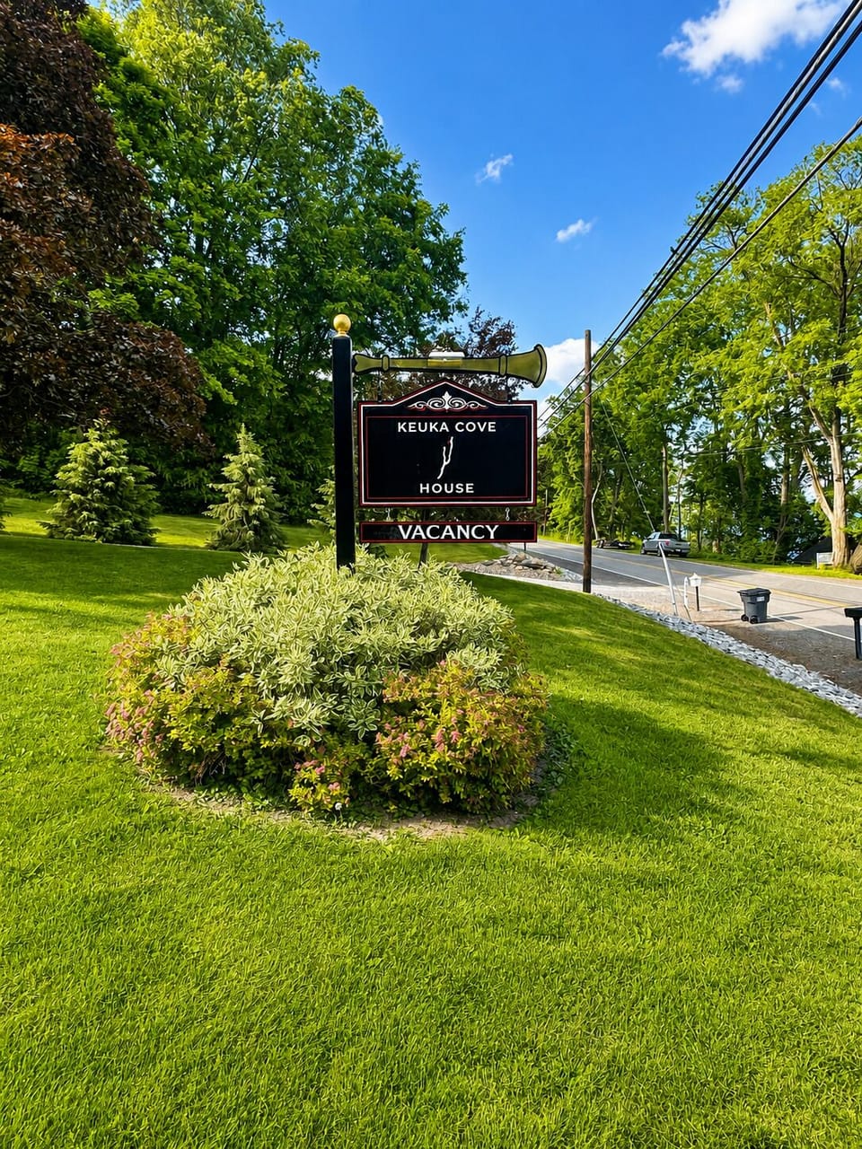 Keuka Cove House sign near the front lawn and driveway entrance.