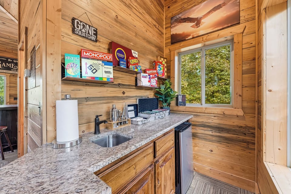 Upstairs kitchenette with mini fridge and games for easy snack breaks.