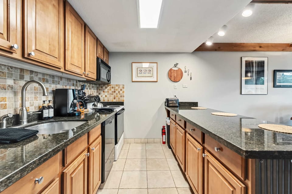 Kitchen: Drip coffee maker, blender, toaster, cooking utensils, tableware