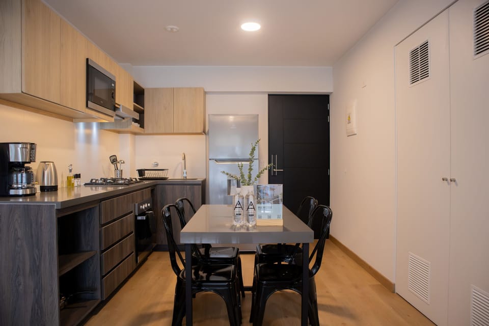 Full view of open kitchen and dining area with modern finishes.