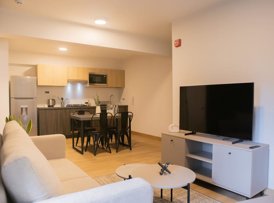 A broader view showing the flow between the kitchen, dining, and living spaces.