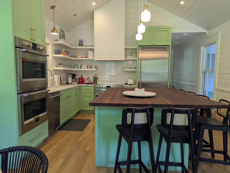 Chef's kitchen, Fulgor Milano induction range and double wall ovens, eat-in island with seating for six.