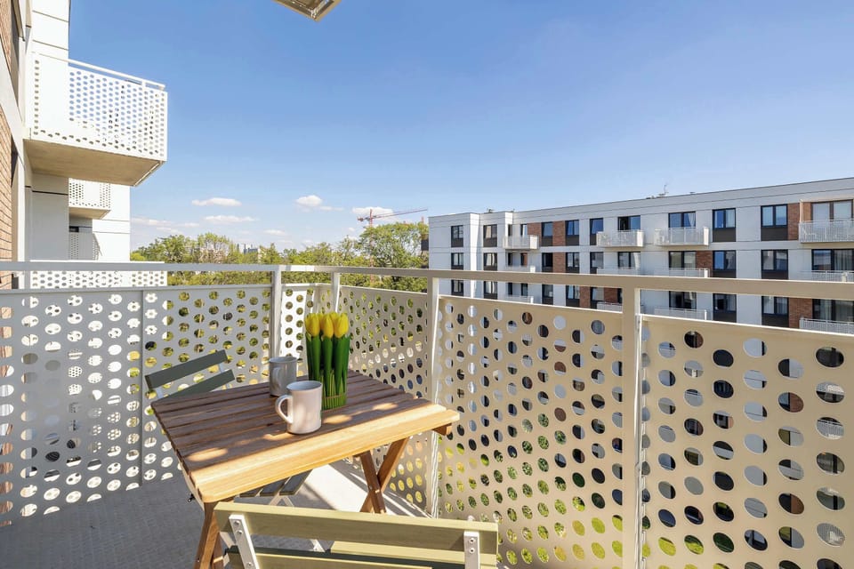 The balcony's stylish design complements the apartment's decor.