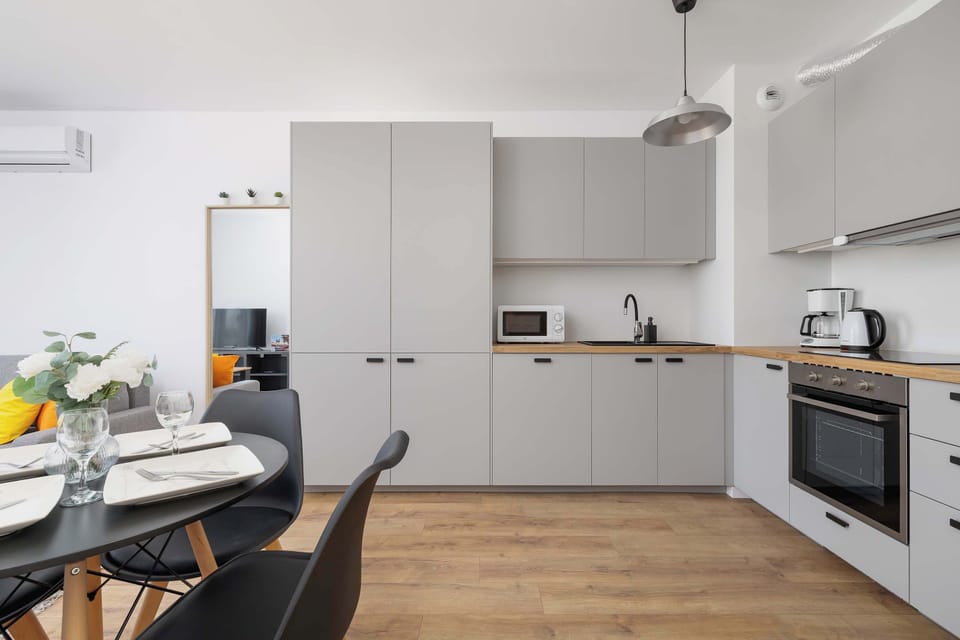 The sleek design of the kitchenette blending seamlessly with the living area.
