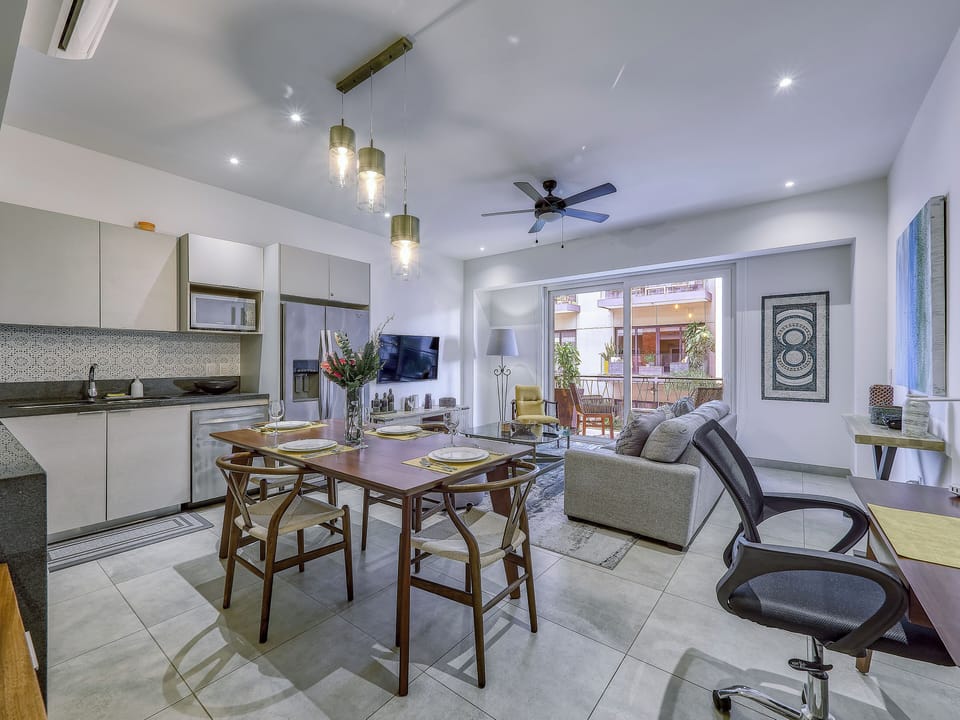 Open-concept layout with kitchen, dining, and living area