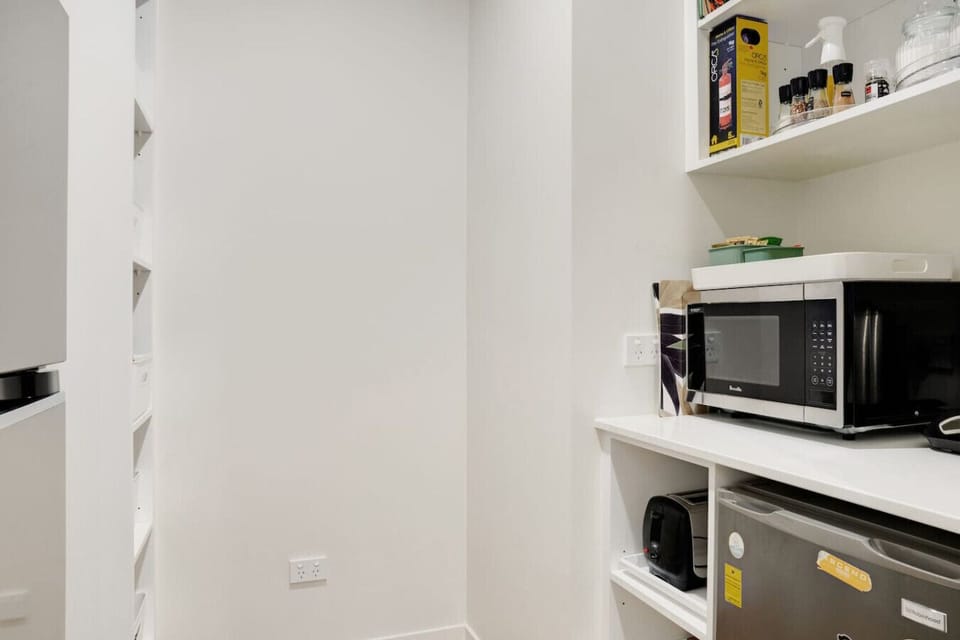 The fridge/freezer, microwave, toaster and jug are all stored in the handy butlers pantry.