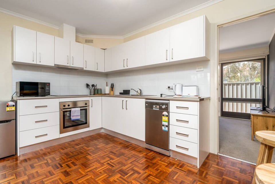 Spotless countertops, sleek appliances, and ample space for cooking and dining in style.