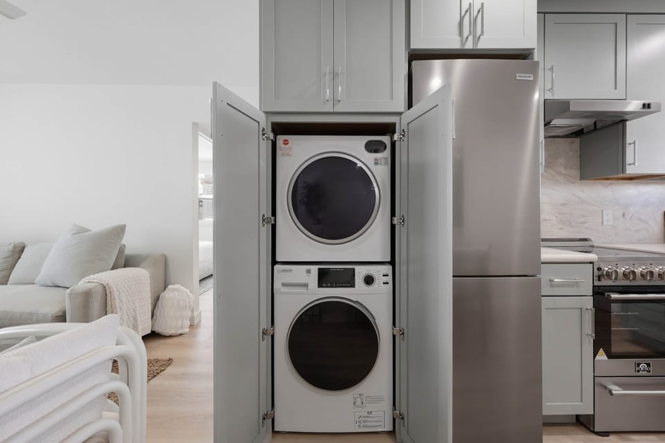 Laundry in cabinets to left of refrigerator