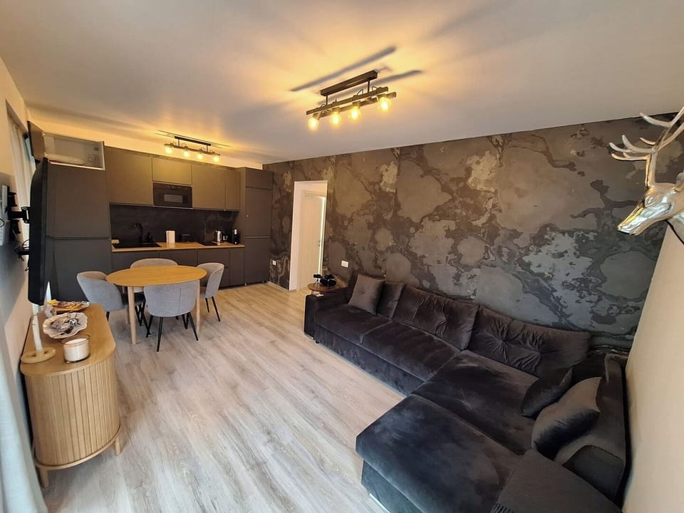 This wide-angle shot captures the flow between the living, dining, and kitchen spaces — perfect for spending quality time with friends or family in a stylish and functional environment.