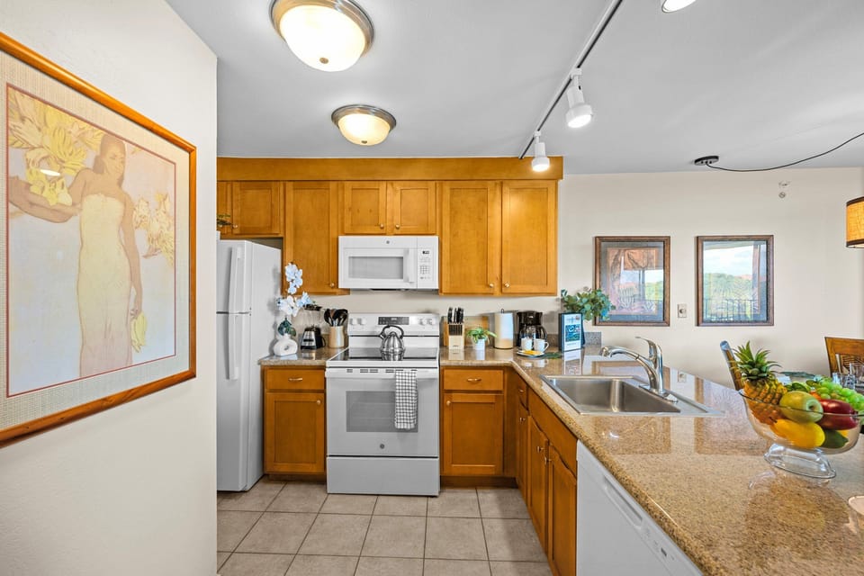 Fully equipped kitchen with a refrigerator, dishwasher, and stove/oven, plus all the essentials for enjoying home-cooked meals.