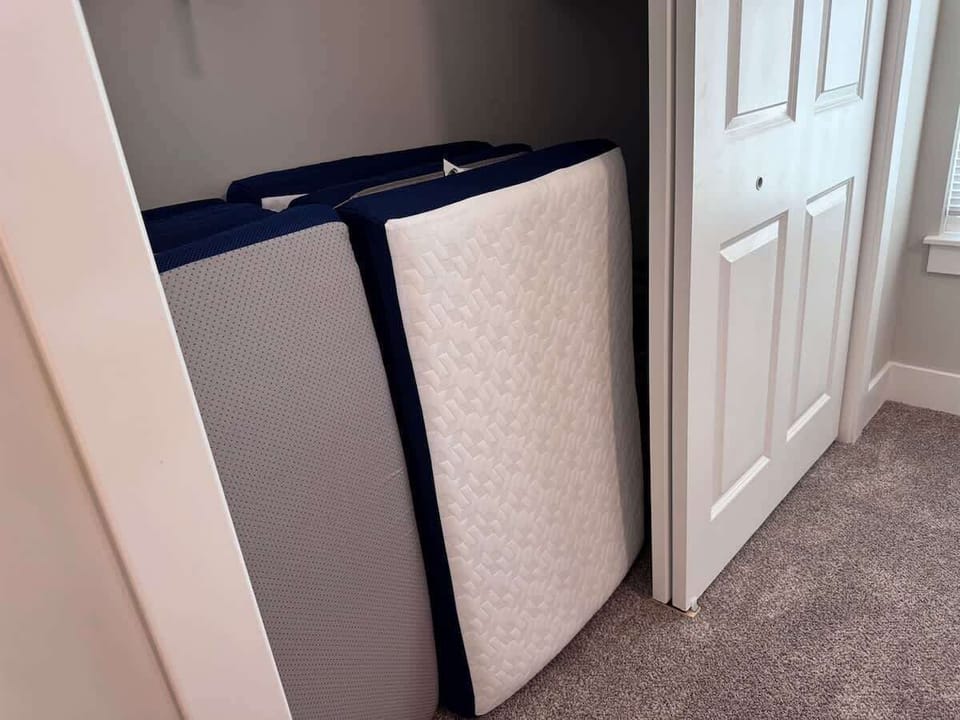 tri-fold twin mats in primary bedroom closet