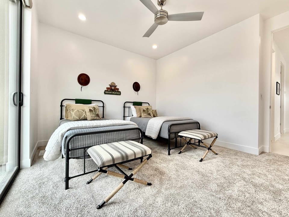 Bedroom 3 offers two twin beds and private balcony access. It is also located right next to another full bathroom.