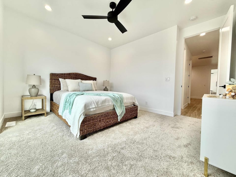Bedroom 3 features a queen sized bed, private balcony access, and is located right next to a full bathroom.