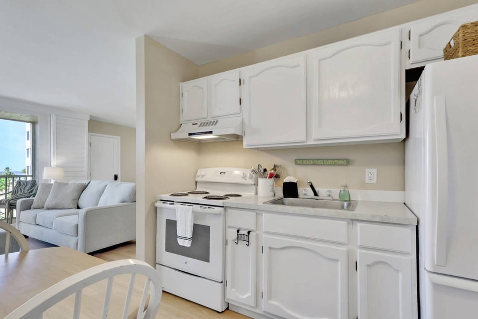 The effecient kitchen has a stove, refrigerator/freezer and microwave; basic cookware and dinnerware are provided.