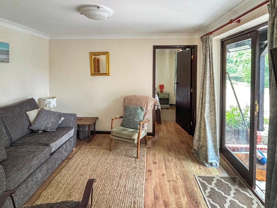 Lounge with views through the patio door | Fushia Chalet - Framlingham Retreats, Framlingham