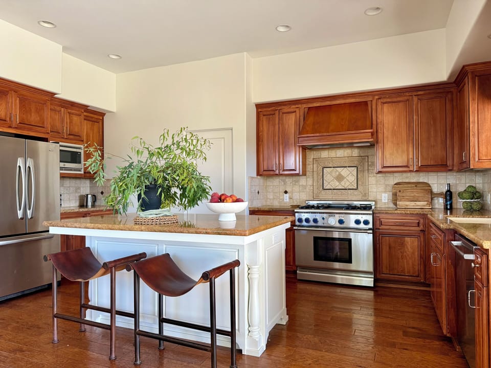 A fully equipped kitchen featuring stainless steel appliances and ample storage cabinets.