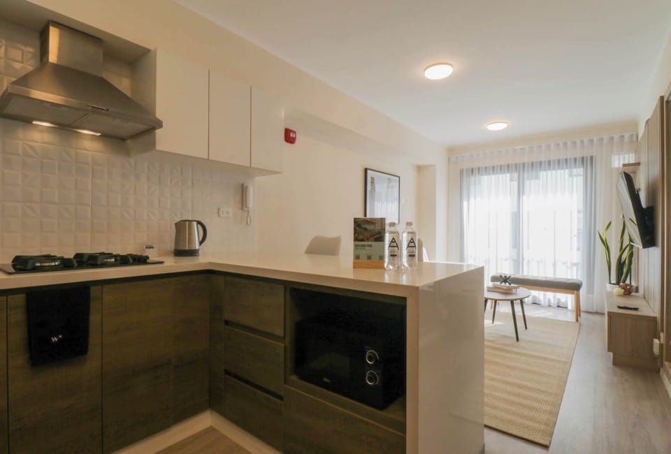 Close-up of the kitchen with a gas stove, oven, kettle, and sleek countertops.